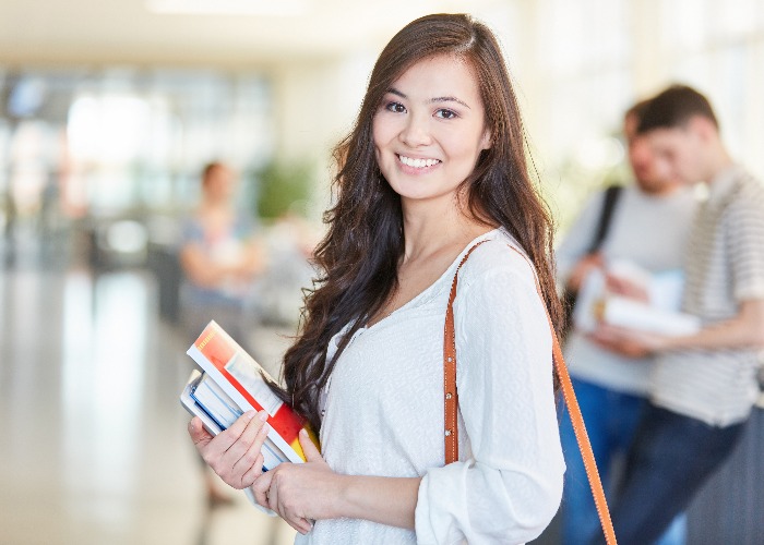 Asian student in university with books