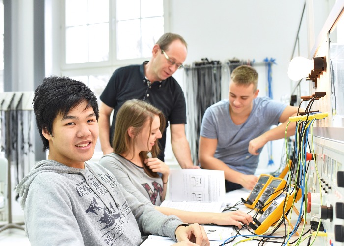 Group of young people in technical vocational training with teacher